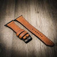 Brown full-grain leather Apple Watch band with contrast stitching and black buckle.