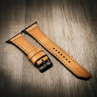 Apple Watch Leather Band in full-grain tan leather with black buckle and contrast stitching.