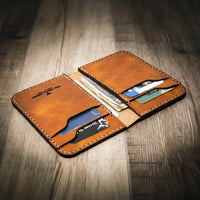 Handmade western vertical leather wallet in walnut brown color, open to show card slots and cash pocket.
